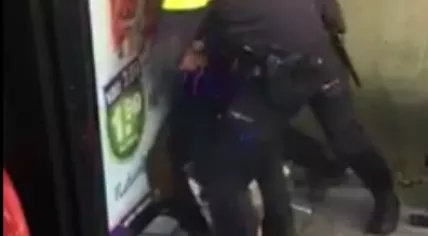 Two cops arresting a man at the Conservatoriumlaan bus stop in Tilburg, 18 Jan 2017