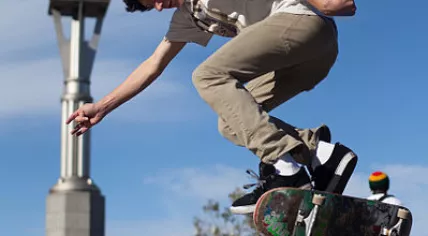 Teenager doing a kickflip on a skateboard 