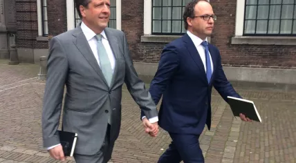 Alexander Pechtold and Wouter Koolmees walk hand in hand to support a gay couple beaten up for holding hands in Arnhem