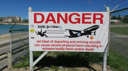 Warning sign at Maho Beach near the Princess Juliana Airport on Sint Maarten