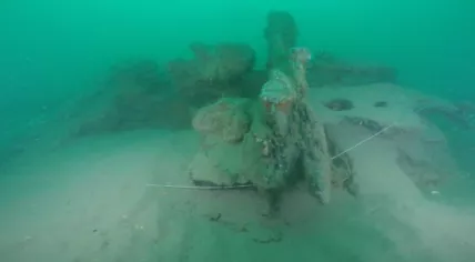 Board and part of a gun on the Rooswijk, which sank on the Goodwin Sands in 1740