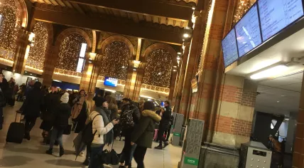 Travelers at Amsterdam Centraal check information boards for train cancellations, 11 Dec 2017