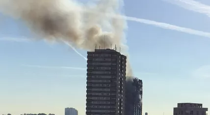 Grenfell Tower in London fire still smoldering after the overnight fire, 14 June 2017