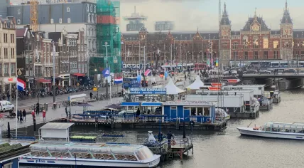 Wind whips through the flags along the Damrak in Amsterdam, 17 Jan 2018