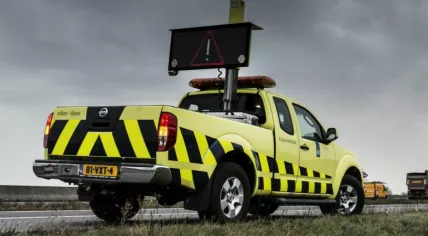 A Rikswaterstaat vehicle warning road users to be careful during stormy conditions