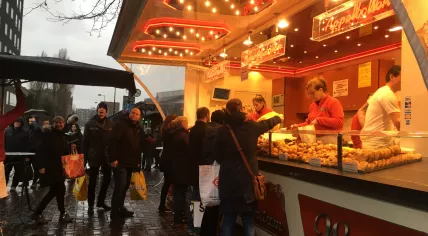 People line up at a food truck in Amsterdam Oost to buy oliebollen in time for New Year's, 31 Dec 2017