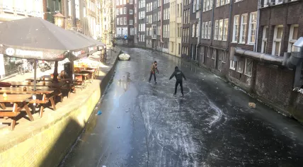 Skaters on the Oudezijds Achterburgwal, a canal in Amsterdam's Red Light District, 2 Mar 2018