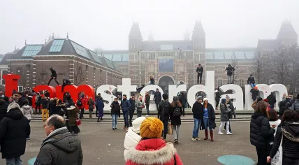 Tourists at the I Amsterdam sign behind the Rijksmuseum