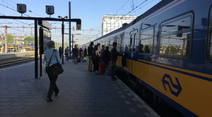 Passengers board a Brussels-bound train at Amsterdam Centraal, 9 May 2018