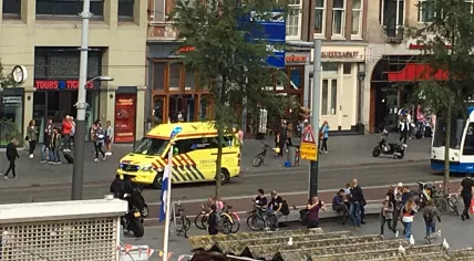 Ambulance racing down the Damrak after leaving the scene of a stabbing and police shooting at Amsterdam CS, 31 Aug 2018