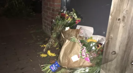 Flowers left outside a home on C.J.K van Aaltstraat where a man was found stabbed to death on 1 September 2018