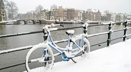 A snow covered bicycle in Amsterdam