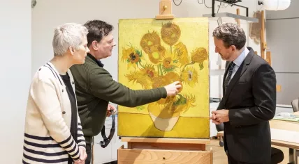 Axel Ruger, Ella Hendriks and Rene Boitelle with Vincent van Gogh's Sunflowers (1889) at the Van Gogh Museum's conservation studio