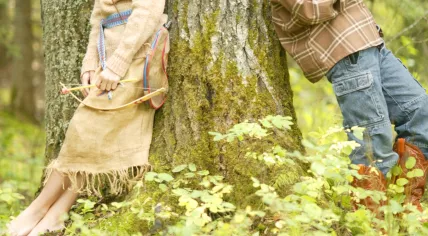 Kids dressed in 'cowboy and Indian' costumes