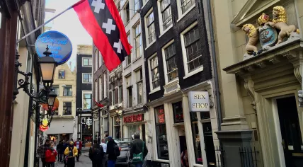 A stiff wind catches the Amsterdam flag flying over Oudebrugsteeg in the city center, 7 March 2019