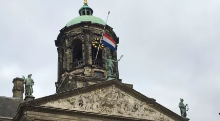 Dutch flag flying at half-staff over the Royal Palace on the Dam in Amsterdam after a mass shooting in Utrecht, 19 March 2019