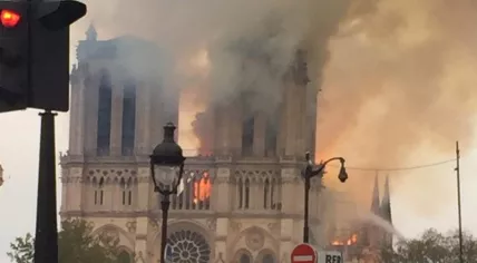 Stunned people watch a devastating fire at Notre-Dame in Paris, 15 April 2019