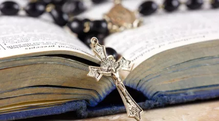 Rosary on an open bible