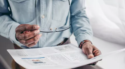 Older man reading a newspaper
