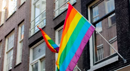 Rainbow flags hanging on a building in Amsterdam 