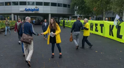 Greenpeace handing out flyers at Schiphol Airport