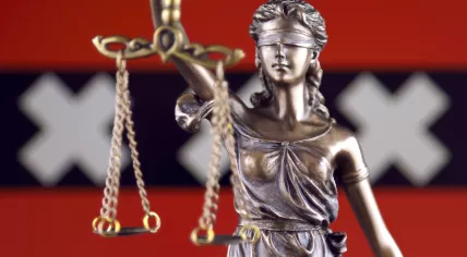 Justice scales and the Amsterdam flag