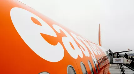 Passengers board an EasyJet aircraft in 2018