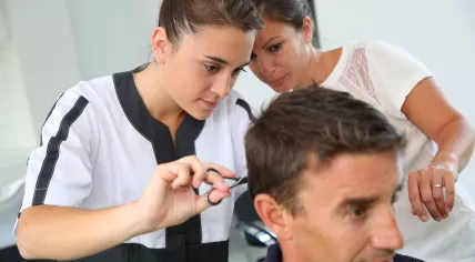 Student learning to cut hair