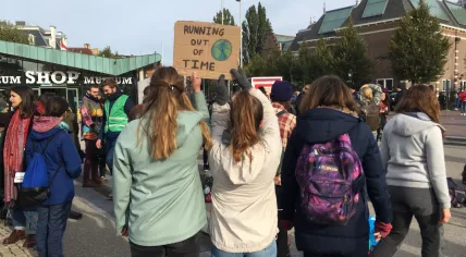 Maud and Emma holding up a sign at a climate protest by Extinction Rebellion in Amsterdam, 7 Oct 2019