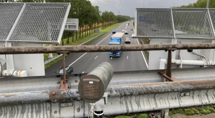 Smart traffic camera mounted at a viaduct to catch drivers using their phones behind the wheel. September 2019