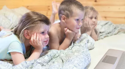 Children watching videos on a laptop