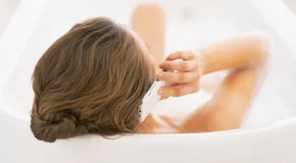Woman talking on the phone in the bath