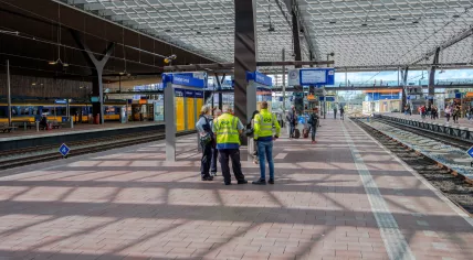 NS employees assisting train travelers at Rotterdam Central Station