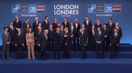 World leaders direct U.S. President Donald Trump towards the next appointment after the opening ceremony of the NATO Summit in London. Dec. 4, 2019