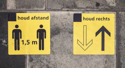 Signs placed on the pavement to remind people of social distancing rules at the Almelo train station. 28 July 2020
