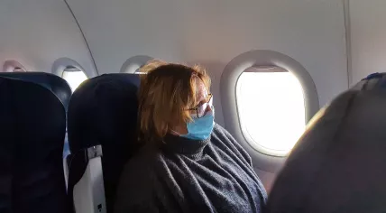 An airline passenger wearing a face mask during an October 2020 flight to the Netherlands
