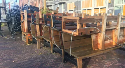 Tables, chairs and benches piled up outside of Nomads restaurant in Amsterdam Oost. 28 October 2020
