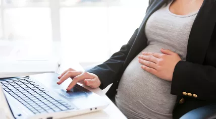 Pregnant woman working on a laptop