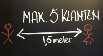 Sign above a shop in Amsterdam Oost to promote social distancing. Nov. 26, 2020