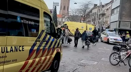 Paramedics and police gather at an Albert Heijn in The Hague where two people were stabbed and the store was set on fire. 2 Dec. 2020