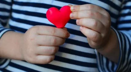 Child holding a heart