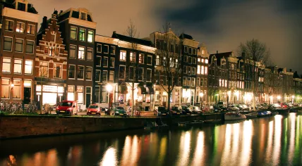 Cars parked along an Amsterdam canal
