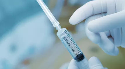 Doctor holding a syringe