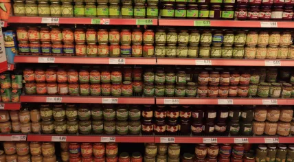 Jars and cans of non-perishable food on a grocery store shelf in Heemstede. May 26, 2019