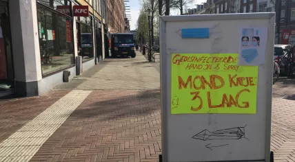 Covid-19: Handwritten sign advertising hand sanitizer, masks for sale in Amsterdam, 16 April 2020