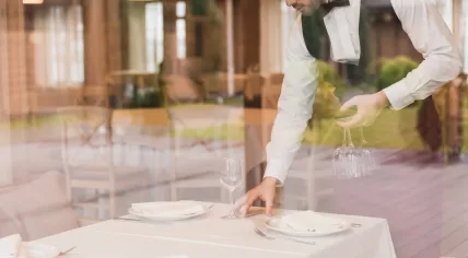 Waiter setting a table