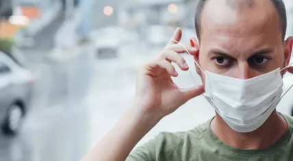Man putting on a mask