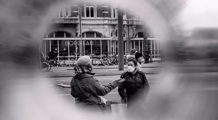 Women wearing respirator masks at Amsterdam's Muntplein. March 2020