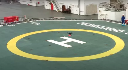 A drone hovers above the helipad on the Pioneering Spirit, moored at the Port of Rotterdam