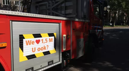 Social distancing promoted on an Amsterdam fire department ladder truck